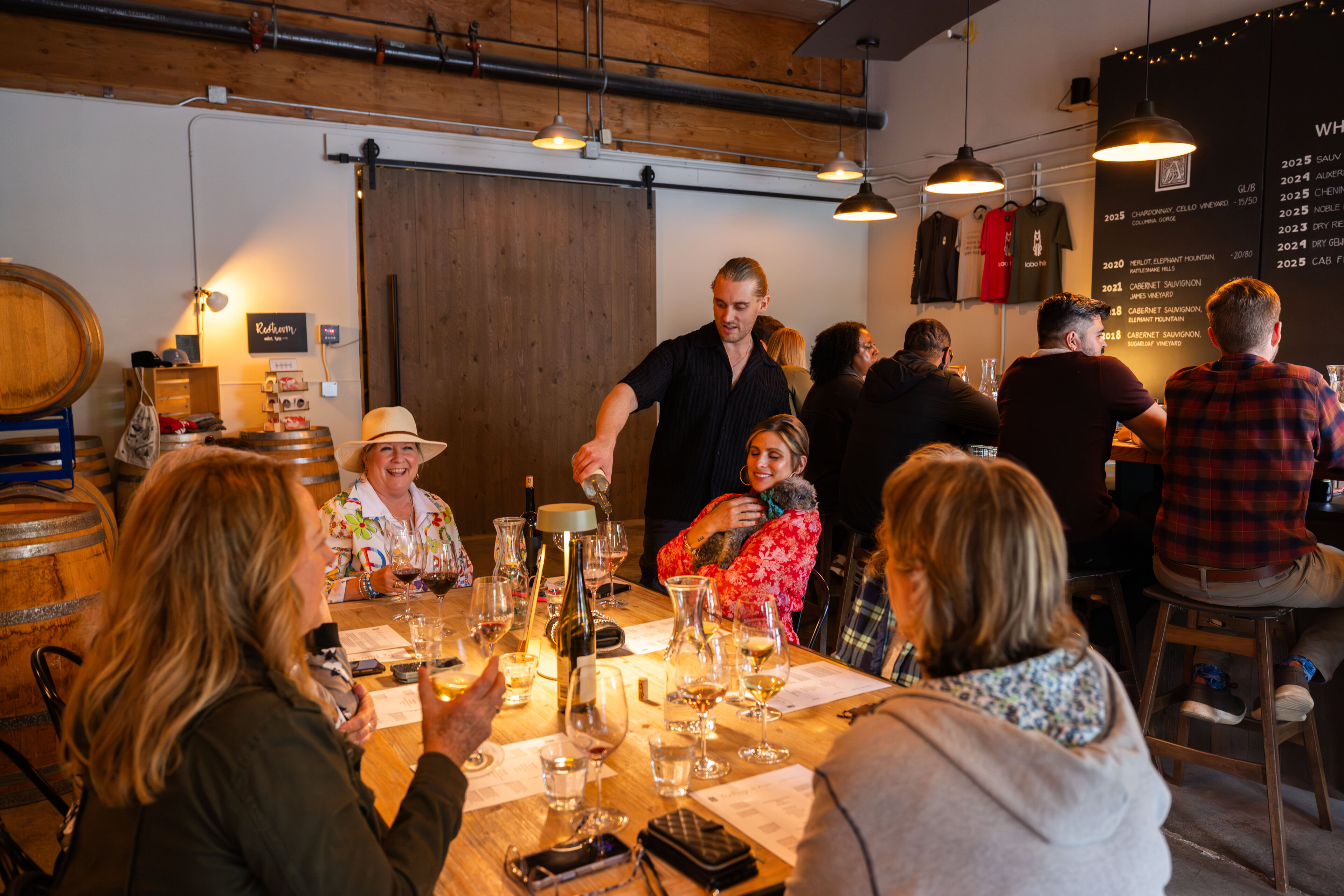 Depict image accurately for accessibility. Group of people enjoying wine tasting at Lobo Hills Wine Co.